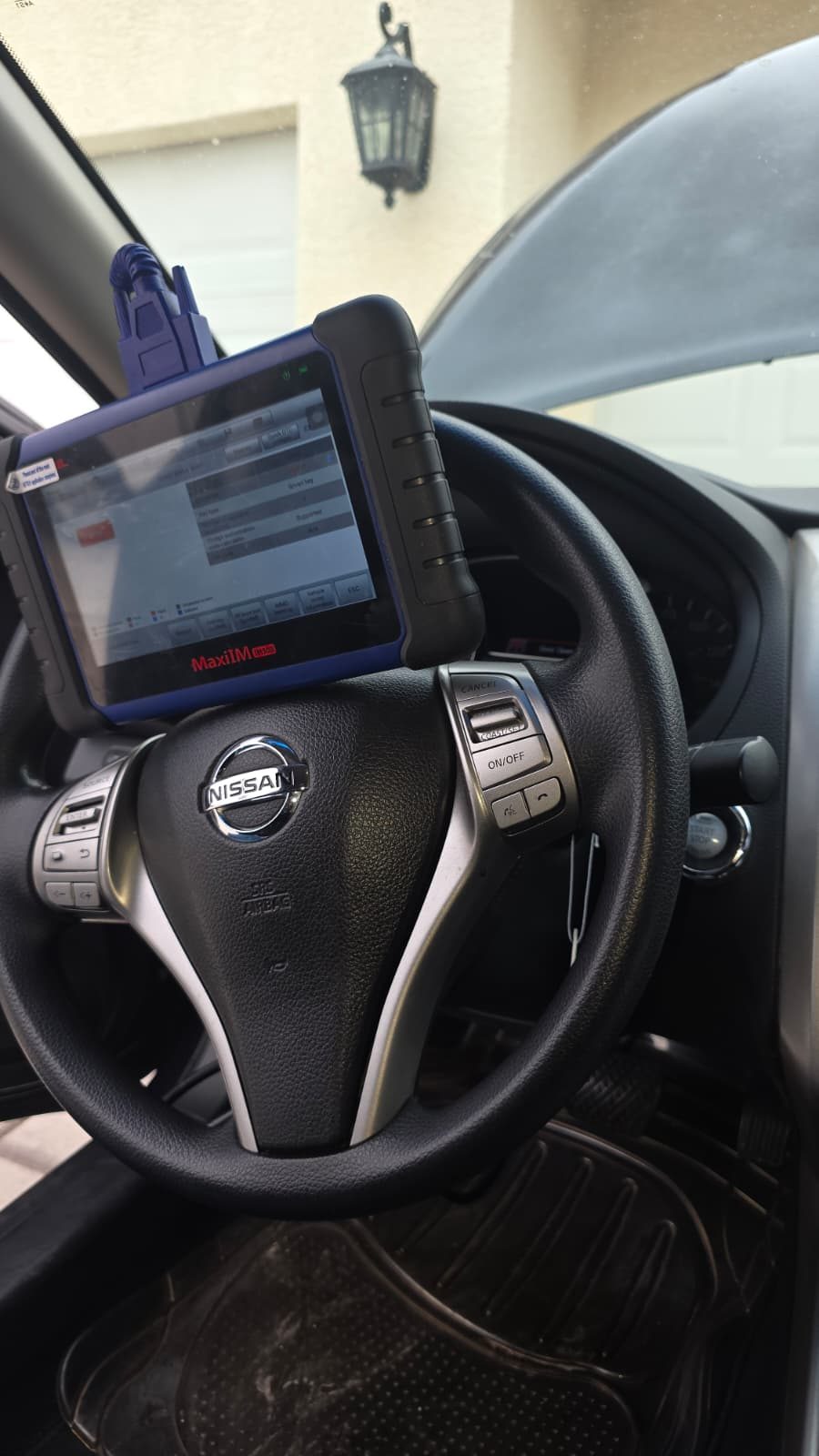 Autel MaxiIM IM608 smart key programmer connected to a Nissan immobilizer — Armor Lock & Safe automotive service