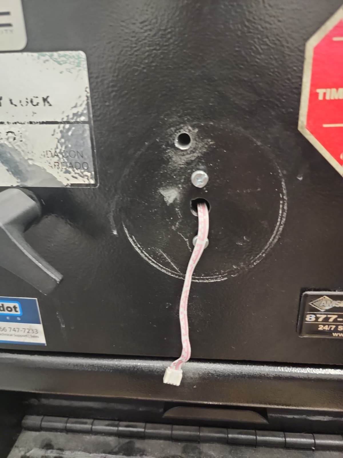 Boroscope access point on a safe with Armor Lock & Safe scoping in progress — visual read of wheel-pack mechanism